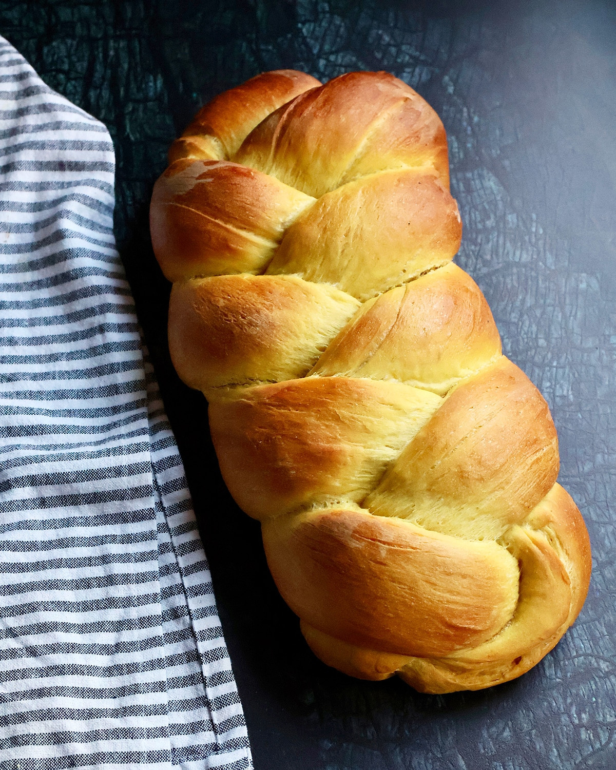 Braided vegan challah looking gorgeous and golden